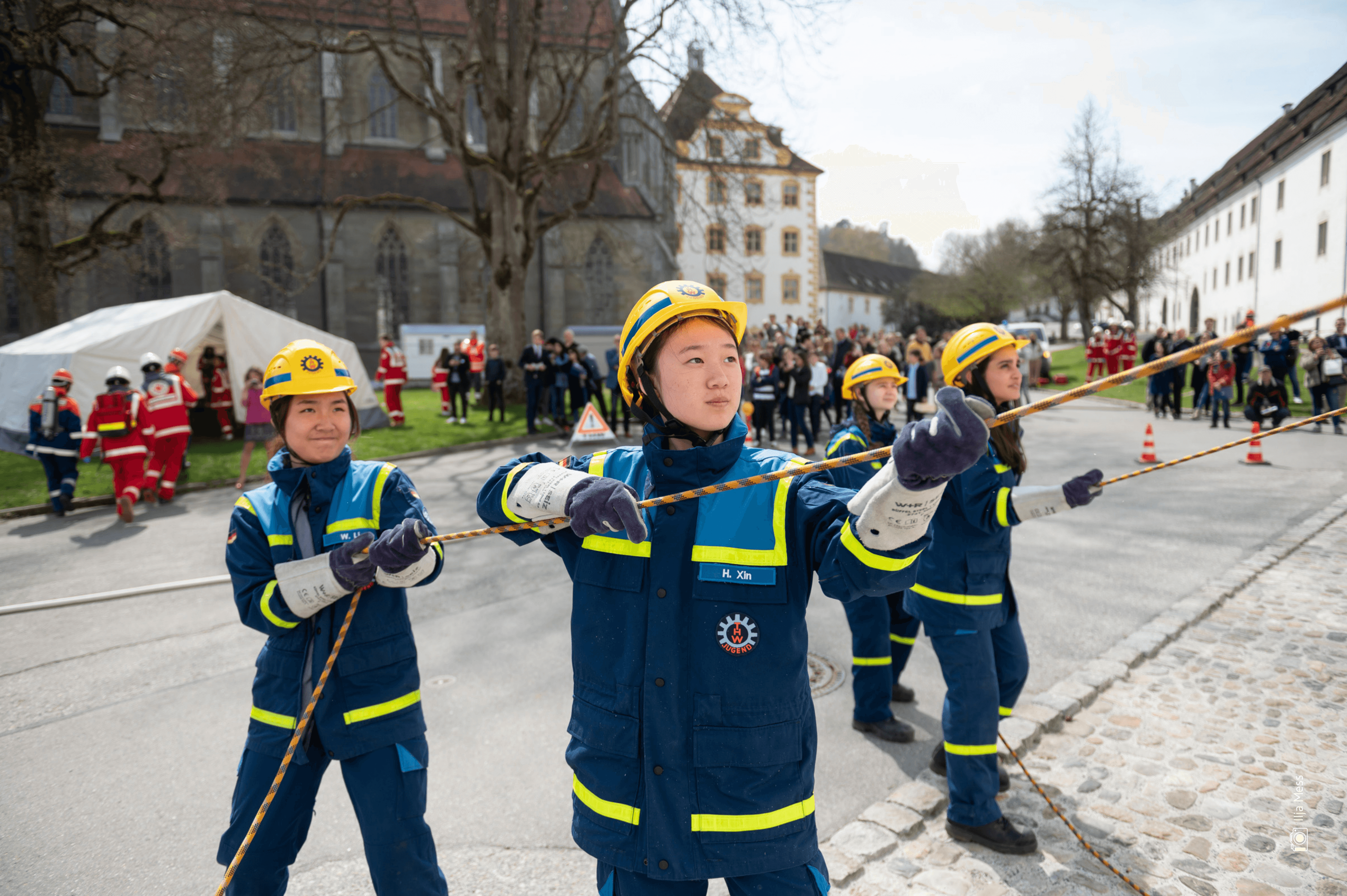 Image of students holding firehoses developing a spirit of service